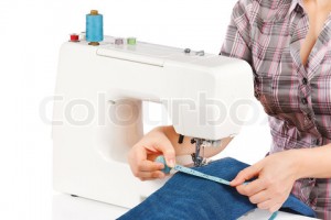 Woman is sewing on the sewing machine